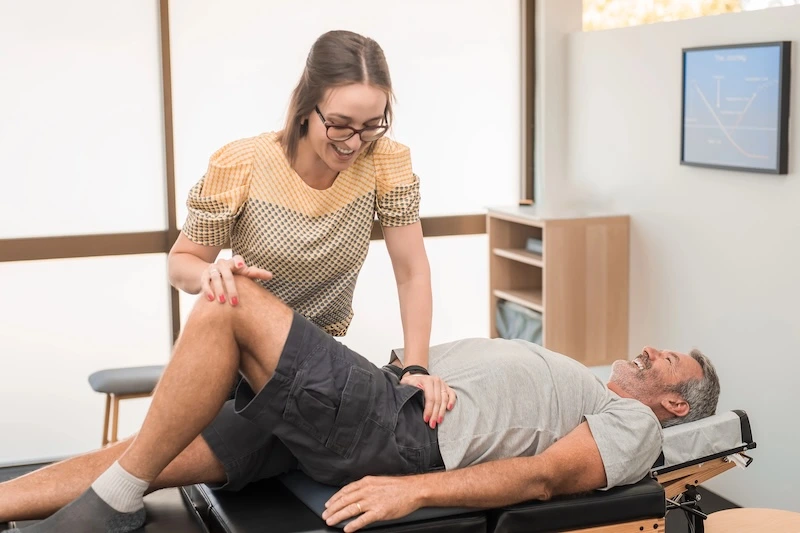 Man on chiropractic table having back aligned