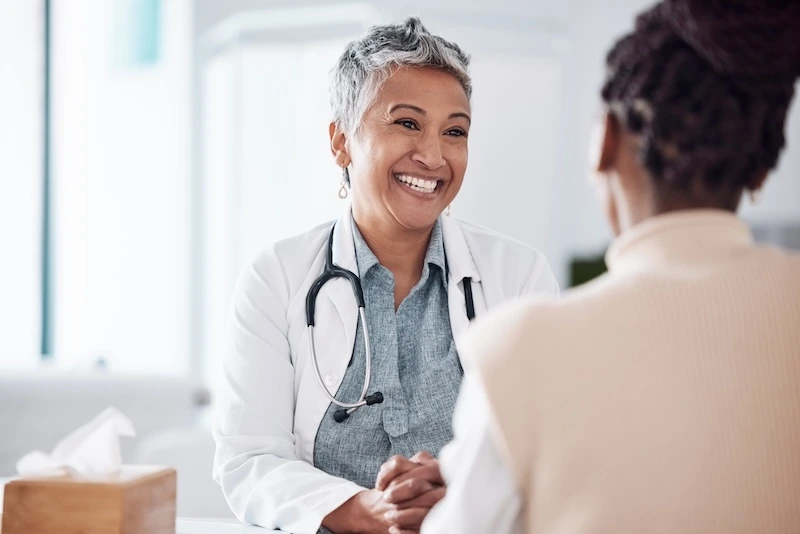 Smiling doctor interacting with a patient