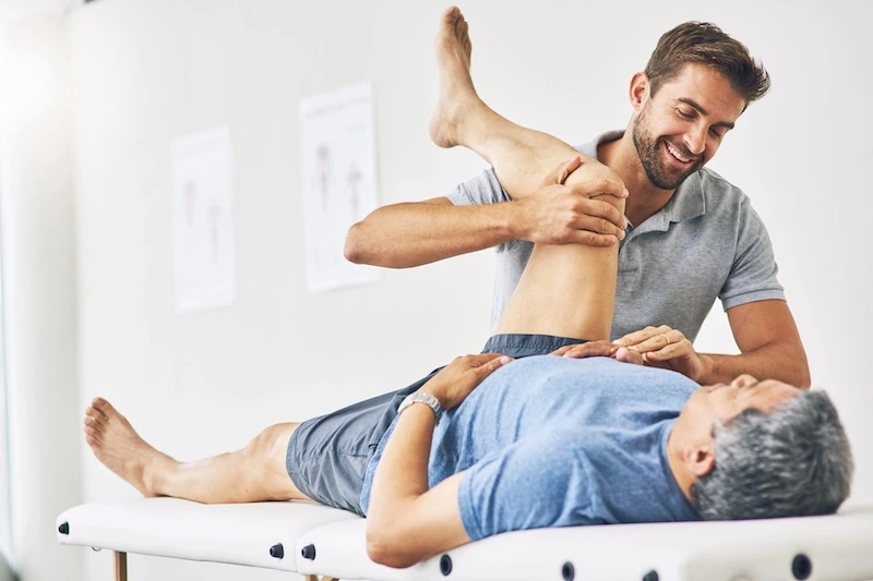 Physiotherapist guiding client through exercise