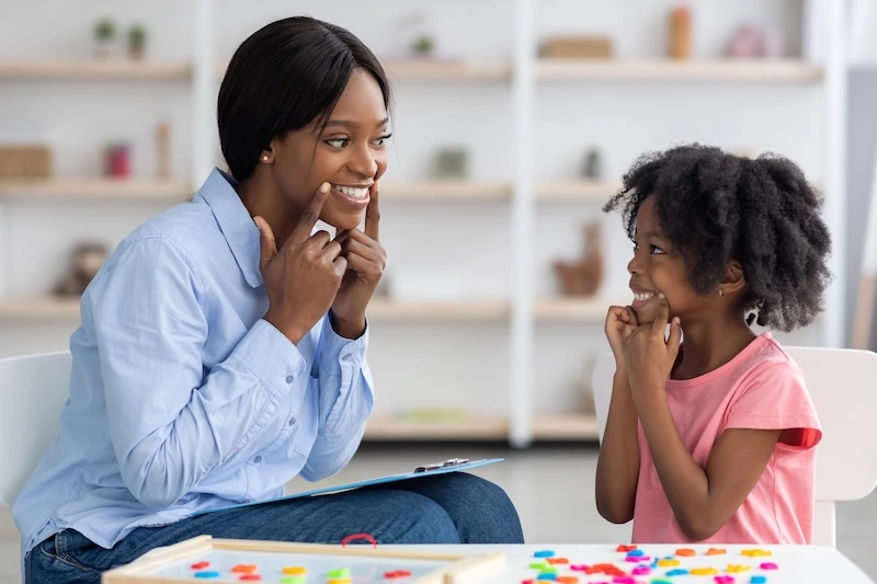 Speech therapist working with a young client